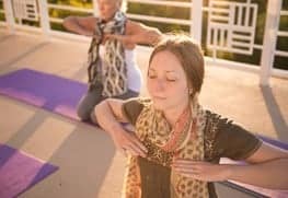 Practices at sunrise at yoga retreat center.