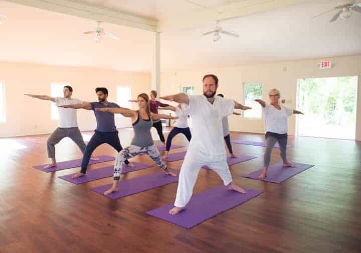 mother and daughter doing yoga and meditation indoor in a glamping