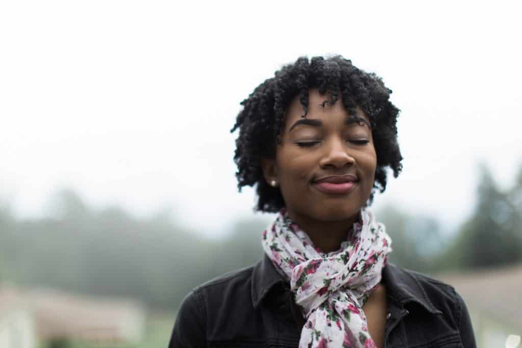 woman smiling with eyes closed