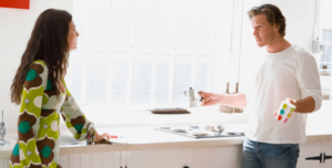 Man and woman in conversation in the kitchen.