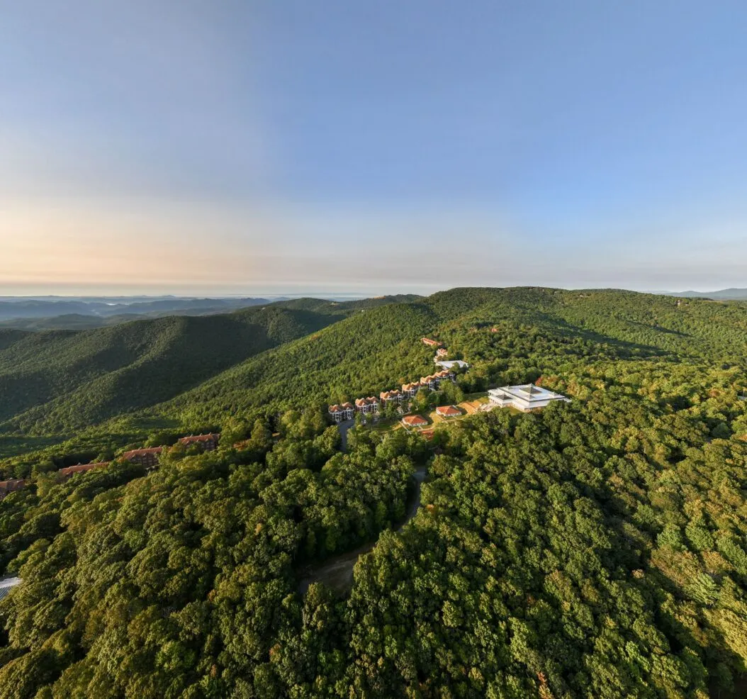 The Art of Living Retreat Center campus surrounded by green mountain wilderness